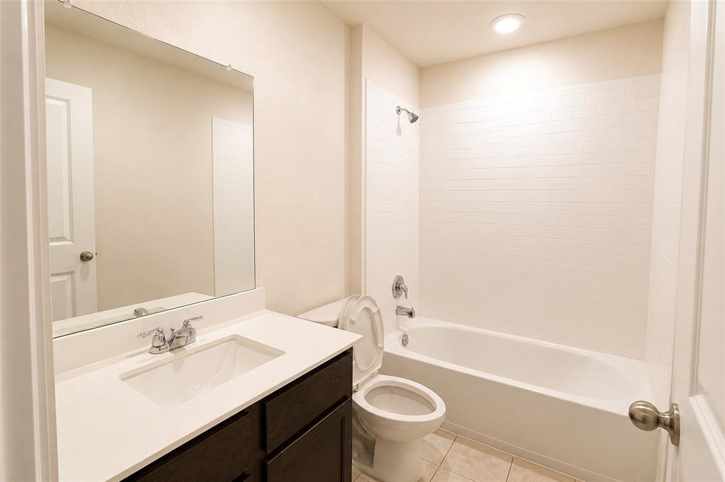 1221 Trevino Road Forney, TX 75126 - Photo 8 of 21 Bathroom featuring a dark wood-finish vanity with a white countertop and integrated sink