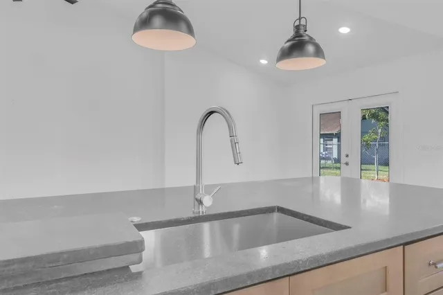 a kitchen with a sink a counter and a dining table