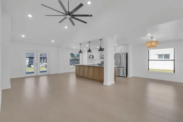 a view of a livingroom with a kitchen and a window