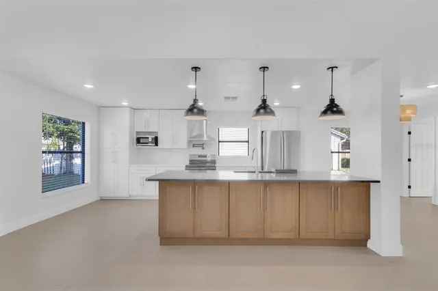 a kitchen with stainless steel appliances granite countertop a sink and cabinets