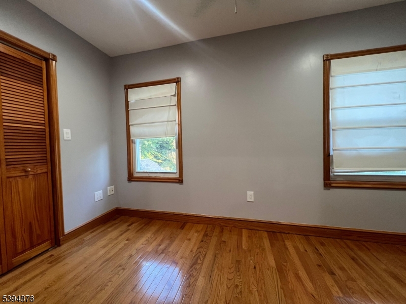 161 Morristown Road Elizabeth, NJ 07208 - Photo 12 of 17 a view of an empty room with wooden floor and a window