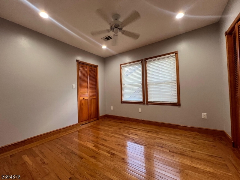 161 Morristown Road Elizabeth, NJ 07208 - Photo 13 of 17 a view of an empty room with window and wooden floor