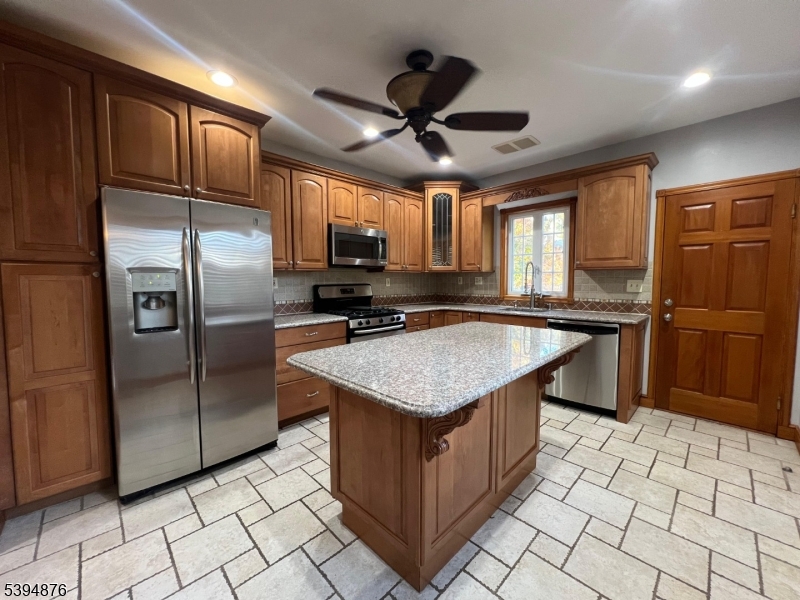 161 Morristown Road Elizabeth, NJ 07208 - Photo 9 of 17 a kitchen with stainless steel appliances granite countertop a sink stove and refrigerator
