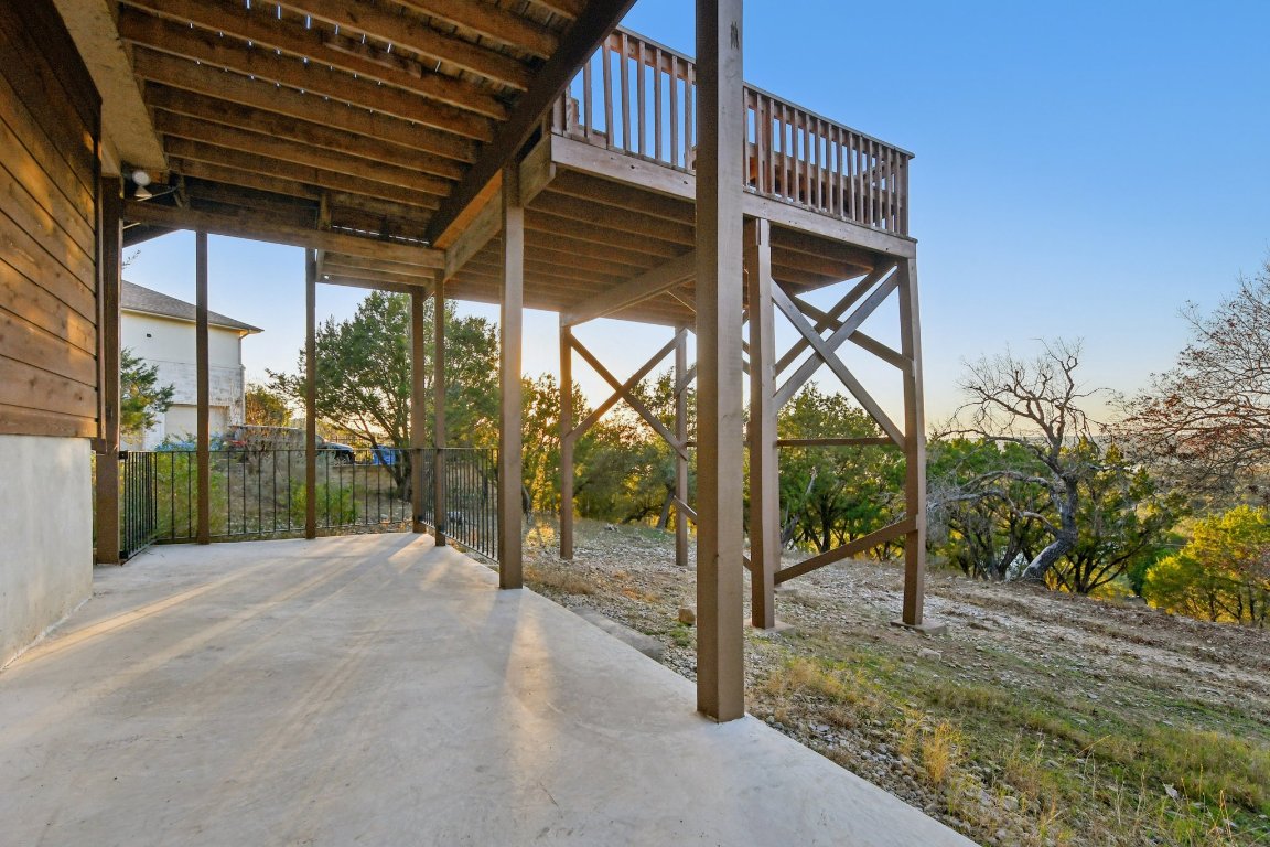 21009 Fawn Ridge Drive Lago Vista, TX 78645 - Photo 37 of 40 Patio terrace at dusk with a wooden deck and a patio