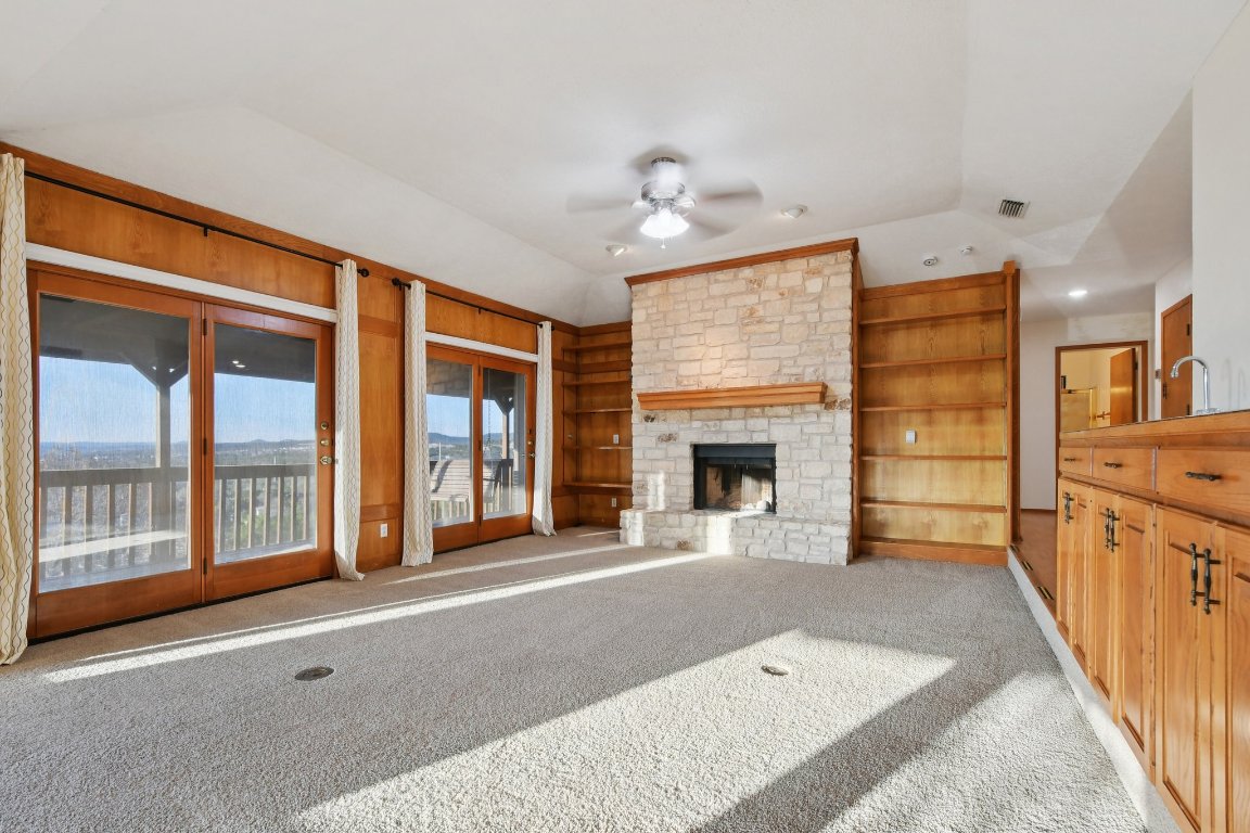 21009 Fawn Ridge Drive Lago Vista, TX 78645 - Photo 10 of 40 a view of an empty room with a fireplace and a window