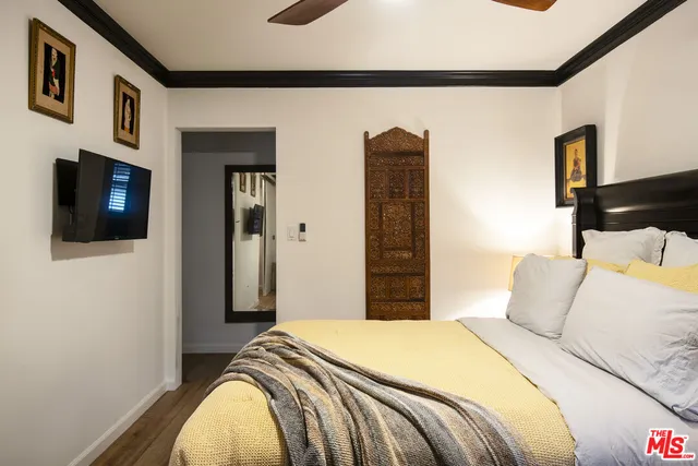 a bedroom with a bed and a flat screen tv