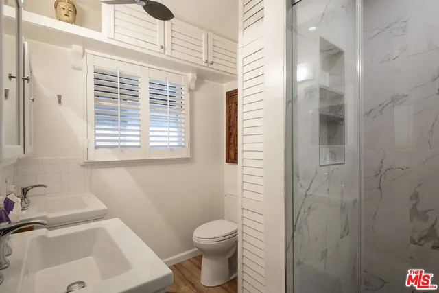 a bathroom with a sink toilet and shower