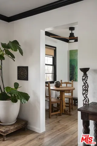a view of a workspace room with wooden floor dining table and chairs