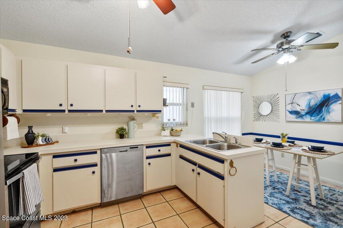 350 Myrtlewood Road Melbourne, FL 32940 - Photo 23 of 46 a kitchen with cabinets appliances a sink and a stove