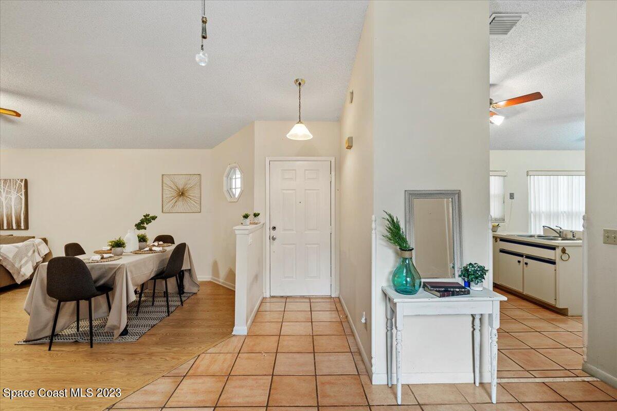 350 Myrtlewood Road Melbourne, FL 32940 - Photo 10 of 46 a living room with furniture and a chandelier
