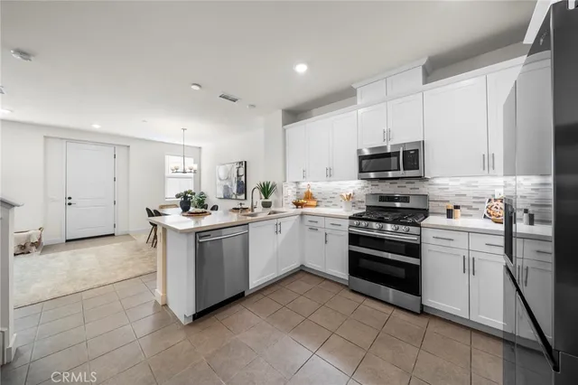 a kitchen with a sink stove and white cabinets