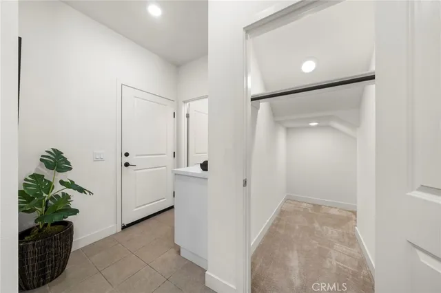 a view of a hallway to rooms