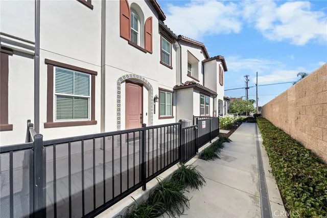 a view of a brick house with a small yard