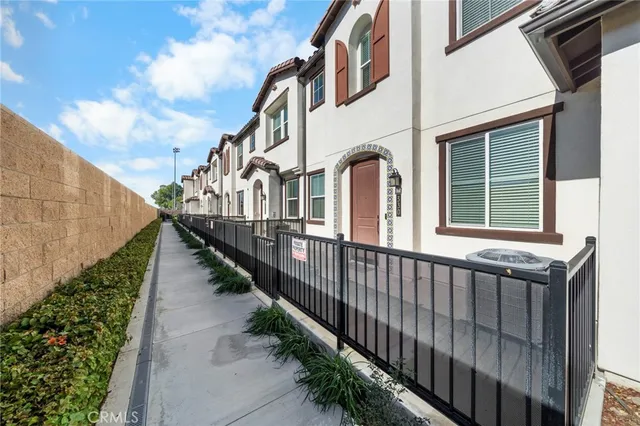 a view of a house with wooden fence