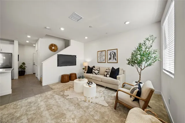 a living room with furniture and a potted plant