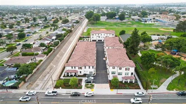 an aerial view of a house with a yard and lake view