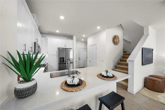 a kitchen with furniture and potted plant