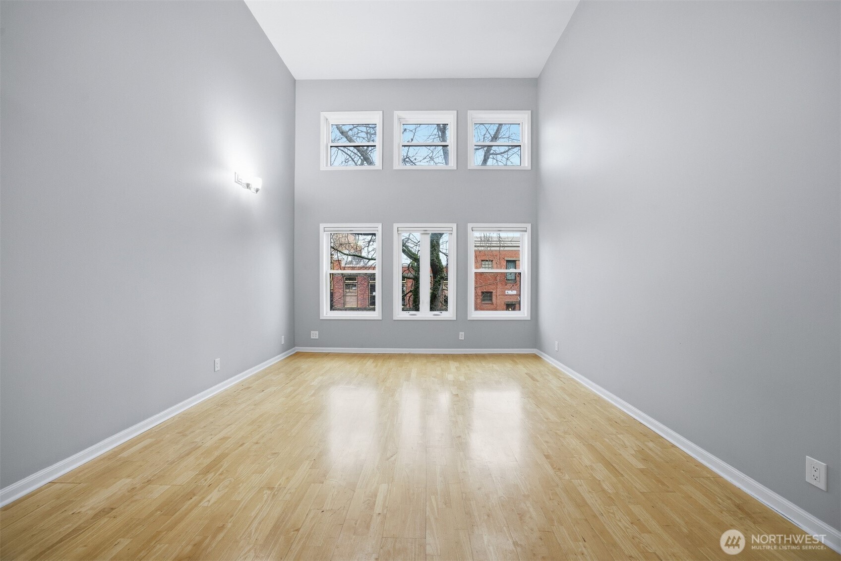 1201 11th Street, Unit 303 Bellingham, WA 98225 - Photo 7 of 34 a view of an empty room with wooden floor and a window
