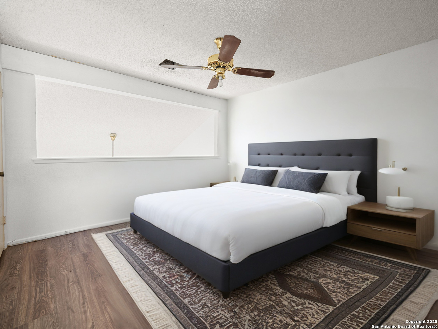 11520 Huebner Road, Unit 302 San Antonio, TX 78230 - Photo 16 of 28 a bedroom with a bed and wooden floor