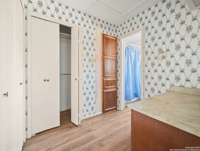a bathroom with a granite countertop sink mirror vanity and toilet