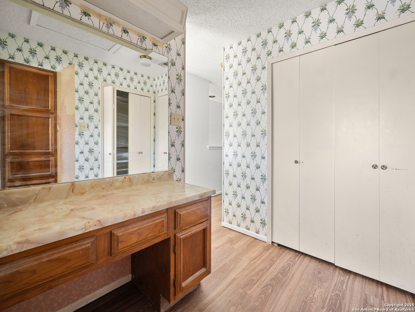 11520 Huebner Road, Unit 302 San Antonio, TX 78230 - Photo 22 of 28 a room with a cabinets and a wooden floor