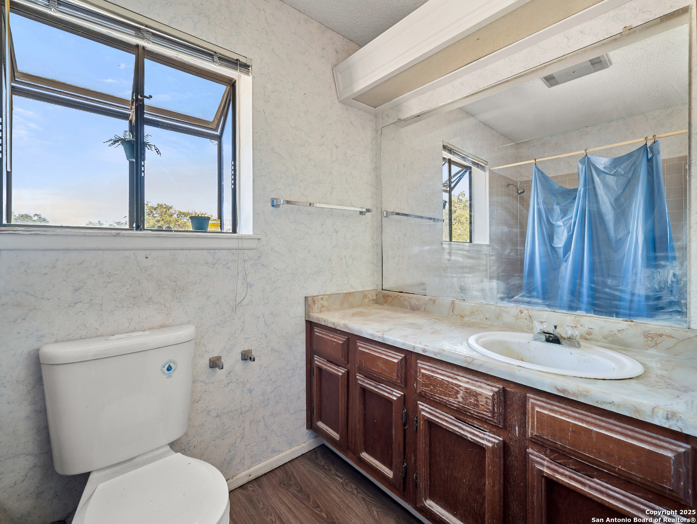 11520 Huebner Road, Unit 302 San Antonio, TX 78230 - Photo 23 of 28 a bathroom with a granite countertop sink mirror vanity and toilet