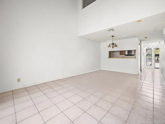 a view of a livingroom with a chandelier furniture and windows