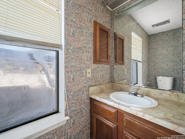 a kitchen that has a sink and a stove