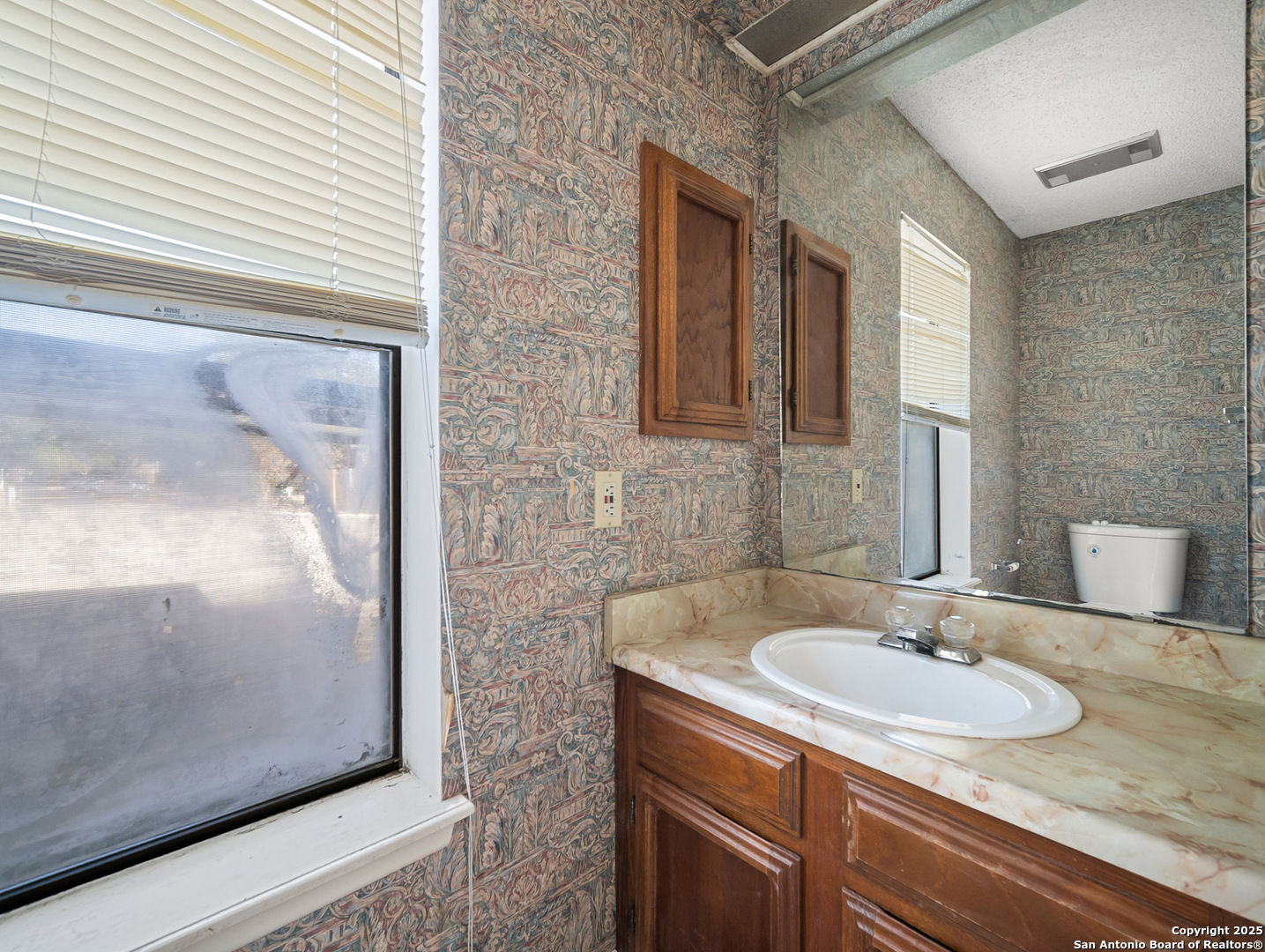 11520 Huebner Road, Unit 302 San Antonio, TX 78230 - Photo 10 of 28 a bathroom with a sink and a mirror