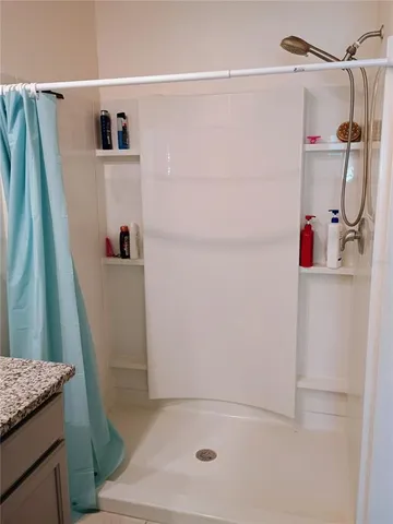 a bathroom with a shower and a sink