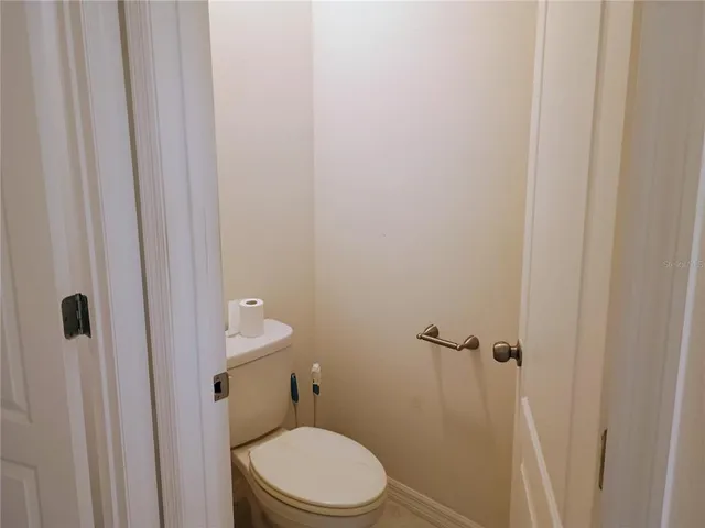 a white toilet sitting next to a shower