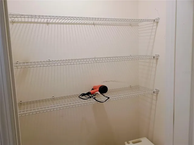 a bedroom with a bed and a lamp on table