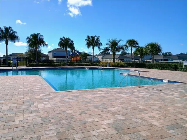 a dining room with furniture water view and a floor to ceiling window