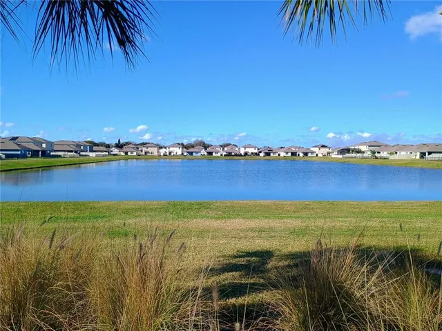 a view of a lake with houses in the background