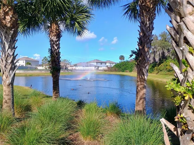 a view of a lake with a house in the background