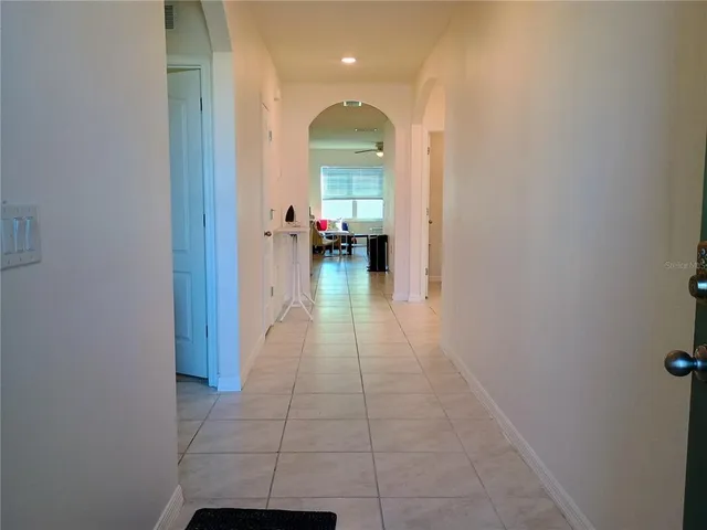 a view of a hallway and a livingroom with a furniture