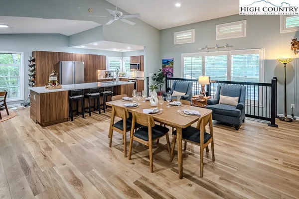a view of a dining room with furniture window and wooden floor