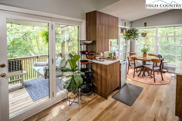 a living room with furniture and a floor to ceiling window