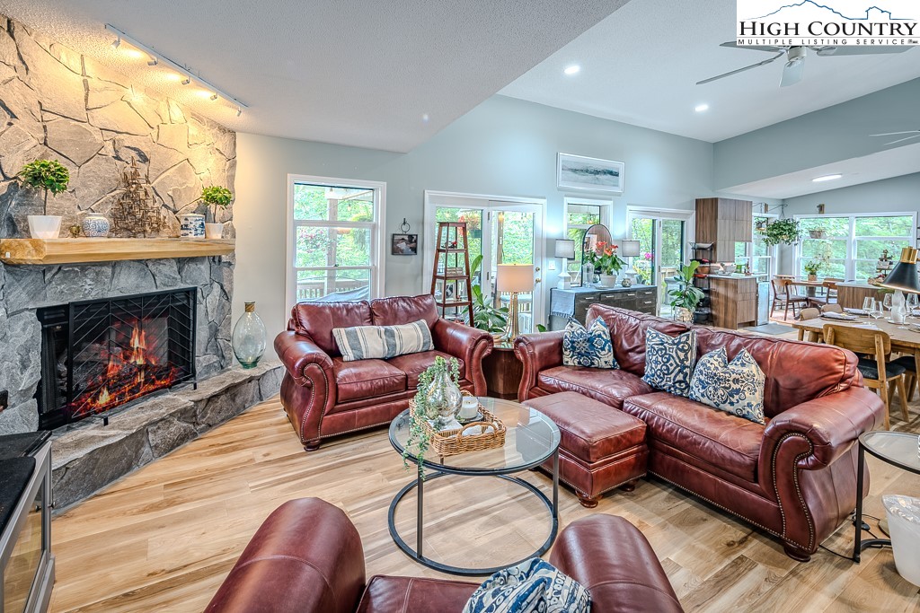 710 Pine Ridge Road Beech Mountain, NC 28604 - Photo 18 of 42 a living room with furniture a window and a fireplace