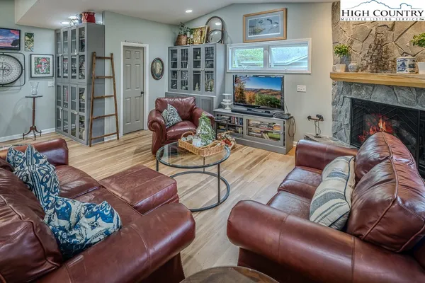 a living room with furniture a flat screen tv and a fireplace