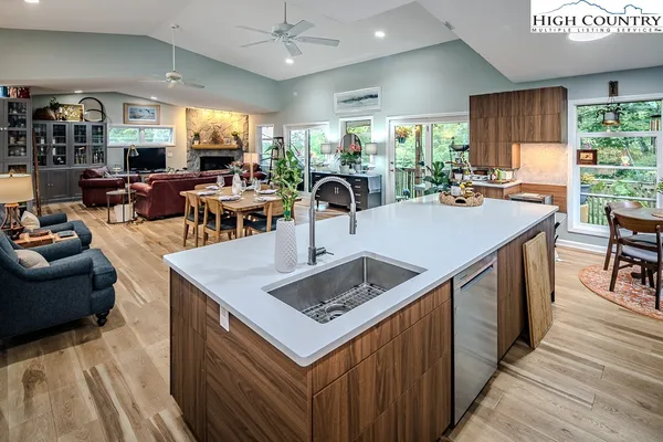 a kitchen with stainless steel appliances granite countertop a sink a stove and a refrigerator