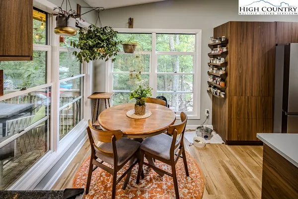 a view of a room with a table and chairs
