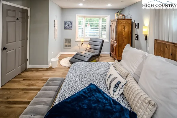 a bedroom with furniture and a window