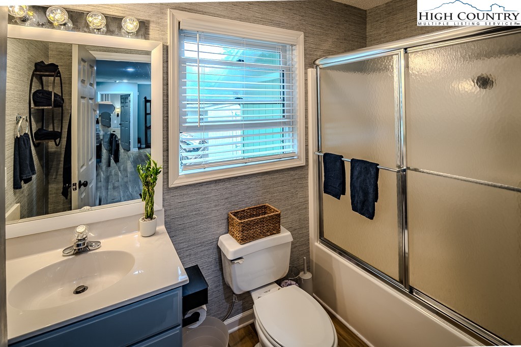 710 Pine Ridge Road Beech Mountain, NC 28604 - Photo 36 of 42 a bathroom with a sink mirror toilet and shower
