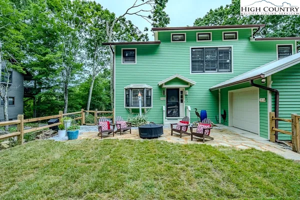 a front view of house with outdoor seating and yard