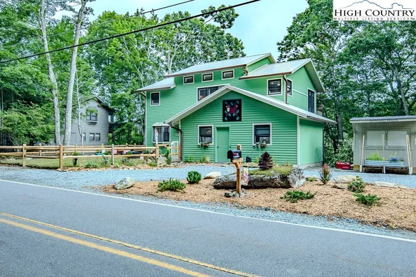 a front view of house with yard outdoor seating and green space