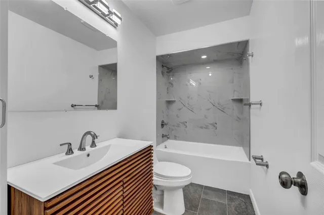 a bathroom with a sink toilet a shower and bathtub