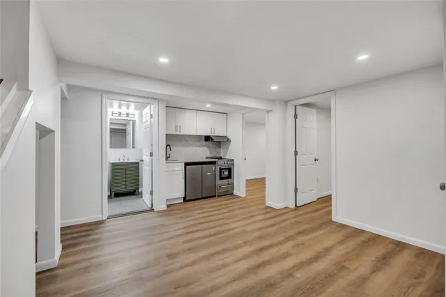 a view of large kitchen with stainless steel appliances kitchen island