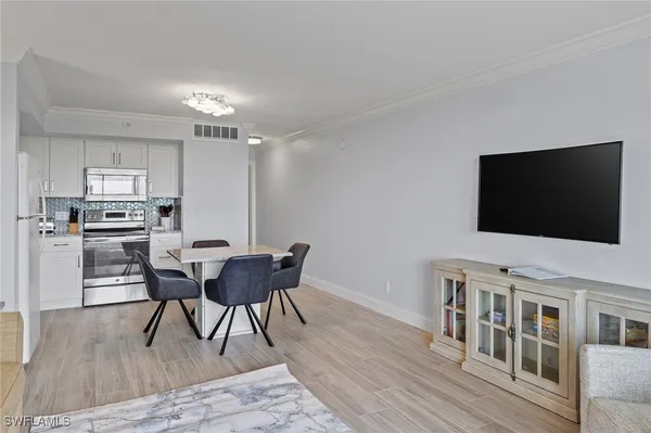 a view of a dining room with furniture and wooden floor