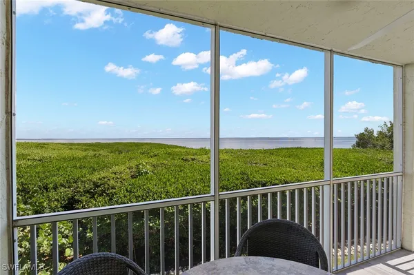 a view of balcony with floor to ceiling windows and a yard